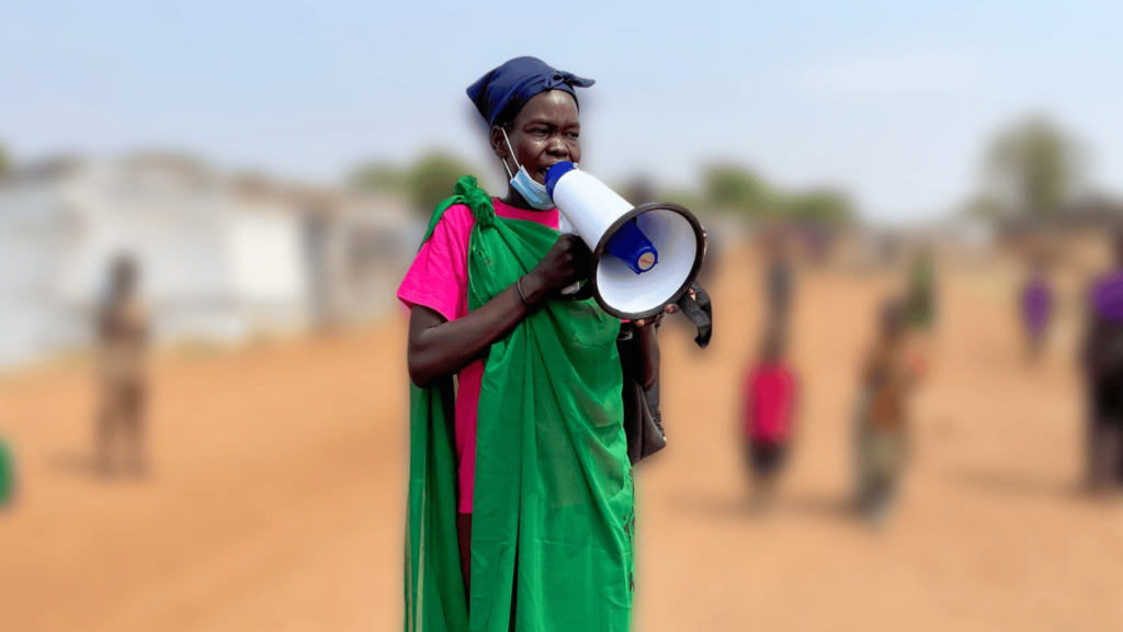 A woman in South Sudan holds a megaphone. She is part of Nonviolent Peace force's unarmed peacekeeping effort.
