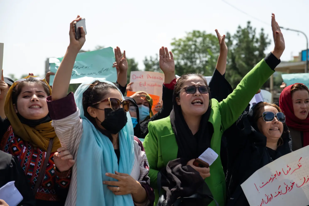 A group of Afghan women hold their hands aloft as they protest against the Taliban in Kabul on the one-year anniversary of the regime's reconquest.