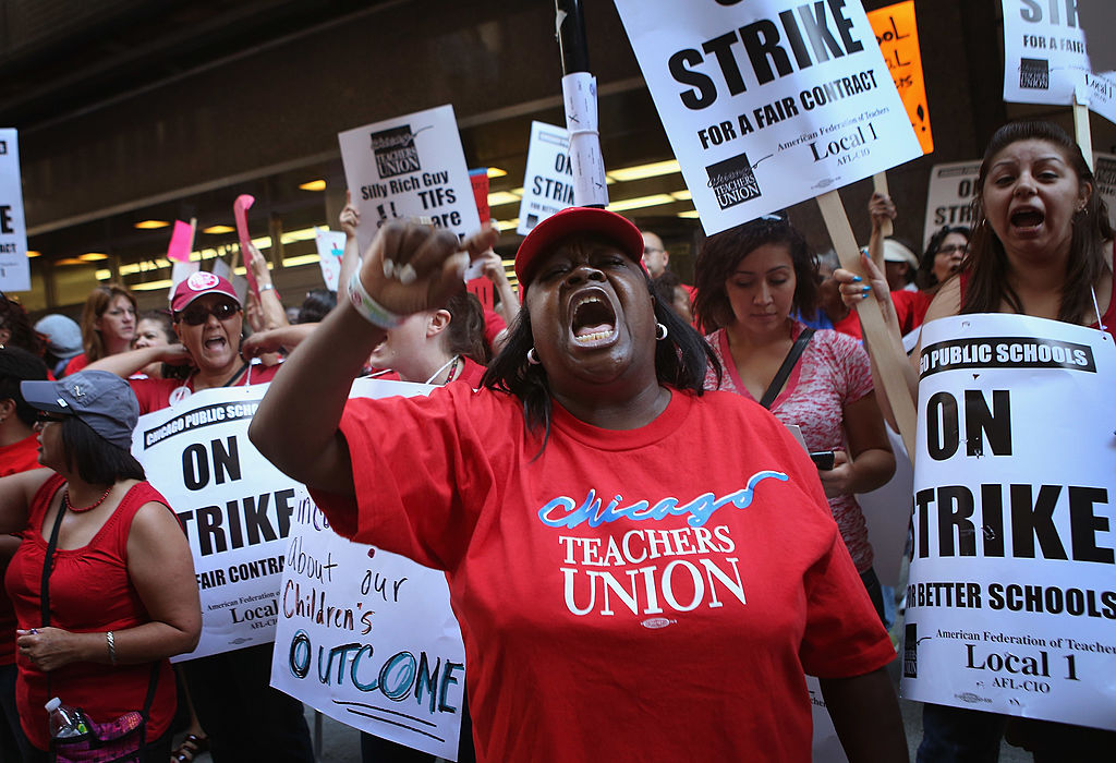 Teachers chant and hold signs during the Chicago Teachers Strike in 2012.