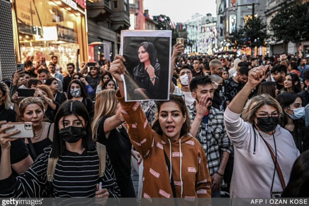 A crowd of Iranian women and allies protests the murder of Mahsa Amini and the restrictive laws for women.