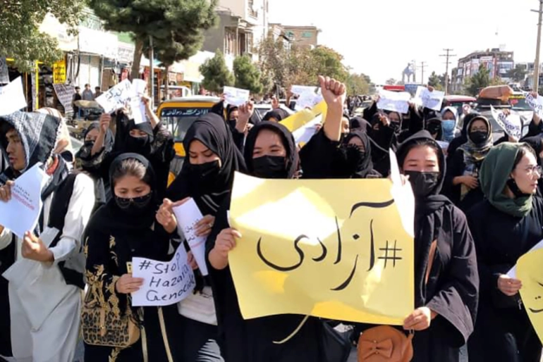 Afghan women and girls march to denounce the attack on a Shia minority school that left 56 female students dead.