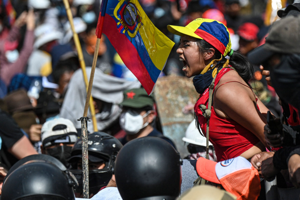 An Indigenous woman in Ecuador shouts above a crowd of protesters during a recent 17-day national strike.