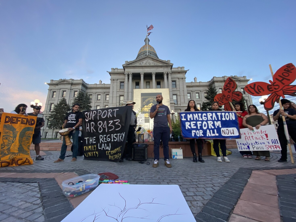 With large banners and human-sized red butterfly cardboard cutouts, migrant rights activists demonstrate for immigration reform in front of a state capitol building. 
