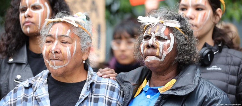 Wearing traditional face paint, Indigenous women in Australia rally against a gas project.
