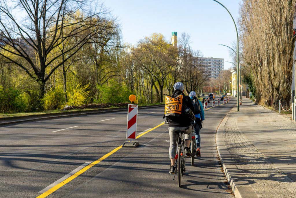 Bicyclists cycle down a bike line in an urban city.