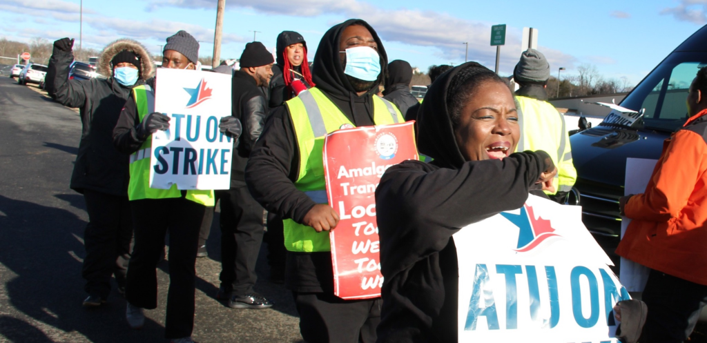 A group of African-American transit workers in Virginia carries signs on the picket line as they strike against privatization. 