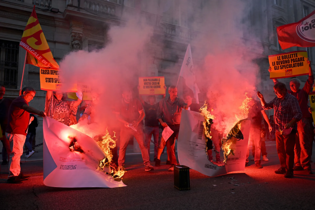 Protestors burn their energy bills during a demonstration against the high cost of living and energy price increases in Rome, Italy.